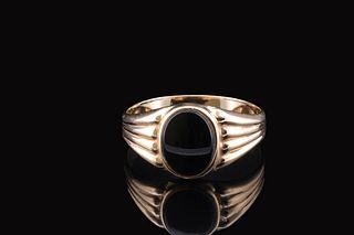 Classic gold ring set with large center Onyx Gemstone.