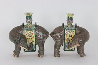 A pair of Chinese famille rose models of elephants carrying vases, 20th C.