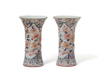 A pair of relief Imari style beaker vases, 19th Century