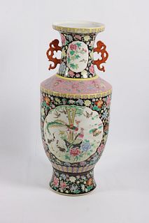 A tall Chinese famille noir floral and bird decorated vase, 20th Century