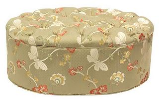 A Contemporary Upholstered Button-Tufted Oval Ottoman Height 15 x width 37 inches.