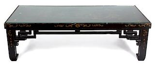 A Black and Gilt Lacquered Low Table Height 16 x width 51 1/2 x depth 24 1/2 inches.