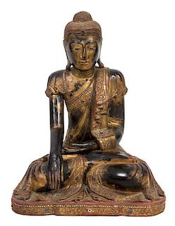 An Indian Gilt Lacquered Seated Buddha Height 24 x width 17 x depth 10 1/2 inches.
