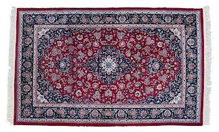 A Persian Wool and Silk Rug 9 feet x 5 feet 8 inches.