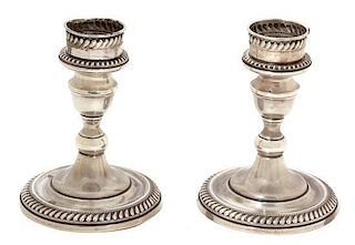 A Pair of American Weighted Silver Candlesticks, Arrowsmith Corp., Brooklyn, NY, having gadrooned and beaded borders.