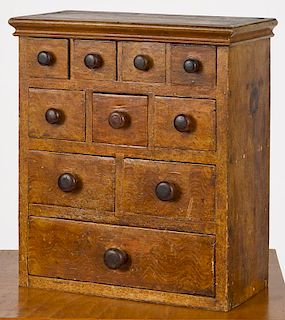 Painted pine apothecary cabinet, 19th c., retaining its original ochre swirl and grain decoration,