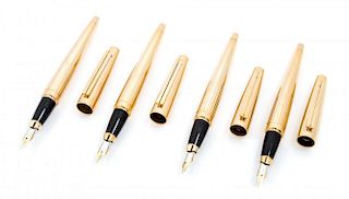 A Group of Four S.T. Dupont Gold-Plated Ellipsis Fountain Pens