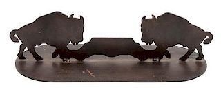 A Pair of Iron Door Stops Depicting Bison in Profile Each height 5 3/4 x width 21 x depth 8 inches.