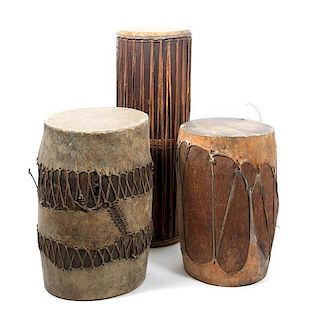 Three Tribal Wood, Leather and Rope Drums Height of tallest 38 3/4 inches.