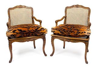 A Pair of Louis XV Style Oak Bergeres Height 35 x width 25 x depth 18 1/2 inches.