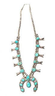 A Navajo Silver and Turquoise Squash Blossom Necklace Length 25 plus naja height 2 /14 x width 2 1/2 inches.