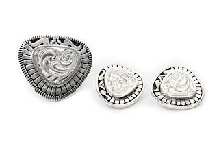 A Navajo Silver Ring and Matching Earrings, Leonard Nez Ring 1 1/2 x 1 5/8 inches.