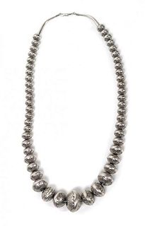 A Navajo Graduated Tooled Flattened Silver Bead Necklace Length 24 inches.