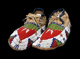 A Pair of Sioux Hard Soled Men's Beaded Moccasins Length 10 1/2 inches.