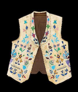A Cree Beaded Hide and Fabric Vest Height 25 x width 19 inches.
