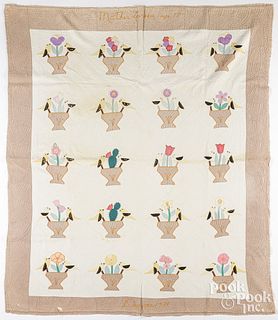 Appliqué quilt with birds perched on flower pots