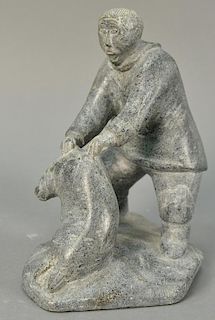 Inuit Eskimo carving Pingu Alaku (1930-1975) Kangiksujuaq (Wakeman Bay) grey soapstone Hunter and Seal, ht. 81/2in. pedestal 