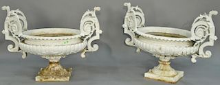 Pair of Victorian iron urns, each with large scroll handles and oval bodies, each set on short iron bases, signed J.W. Fisk N