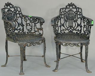 Pair of Victorian iron armchairs with floral and harp backs. ht. 32in., wd. 21in.