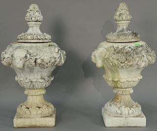 Pair of cement urns in three parts with rams heads on body. ht. 37in. Provenance: Collection of Anne Jones Willis and the lat