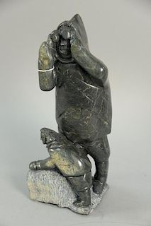 Inuit Eskimo carving, Oolariak Ashoona, Cape Dorset, Hunter/Son with Binoculars, dark green serpetine on pedestal. ht. 15 1/2