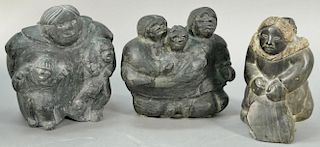 Three large Inuit Eskimo carvings unsigned, two with multiple figures and one of a woman carrying child on her back, all thre