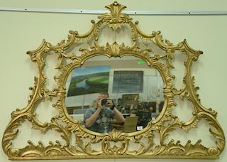 George III style gilt wood over mantle mirror, Chippendale style shaped oval mirror plate with pierced frame with C-scrolls f