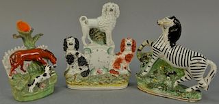 Three piece lot of Staffordshire including zebra, clock with three dogs, and vase with horse and dog, 19th century (as is, ch