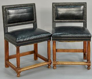 Set of eight custom leather upholstered chairs with brass tacks.
