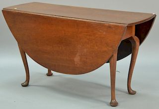 Queen Anne cherry table with oval drop leaves set on cabriole legs ending in pad feet, 18th century. ht. 28in., closed: 18" x