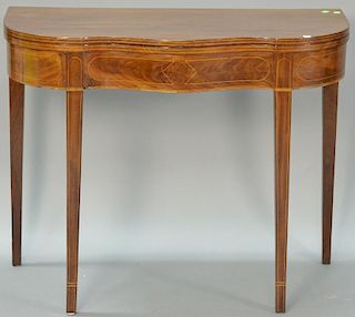 Hepplewhite mahogany inlaid game table with serpentine front on tapered legs. ht. 29in., wd. 36in., dp. 17in. Provenance: Col