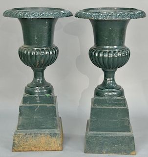 Pair of Victorian iron urns on square pedestal bases (one piece). ht. 44in., dia. 22 1/2in. Provenance: Collection of Anne Jo