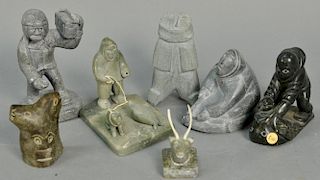 Seven Inuit Eskimo carvings to include Tukas Qumaluk Povungnituk grey soapstone Boy with Radio, unknown artist Arctic Quebec 