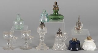 Ten assorted glass fluid lamps.