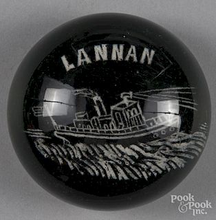 White frit paperweight, with a tugboat, inscribed Lannan on a translucent green ground, 3 1/4'' dia
