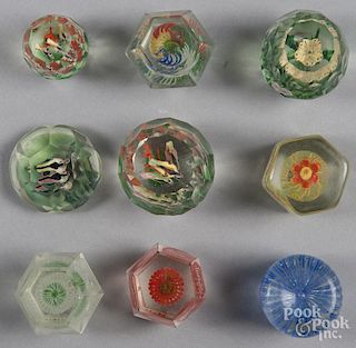 Group of nine Chinese faceted paperweights, ca. 1920, with various interior designs, including birds