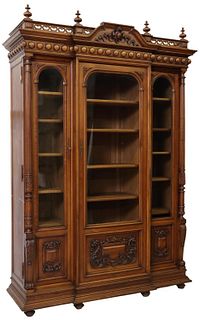 FRENCH CARVED WALNUT BREAKFRONT BOOKCASE