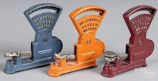 Three Kilgore cast iron Toledo toy counter scales, 6'' h.