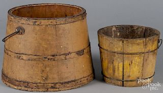 Two painted buckets, ca. 1900, retaining their original mustard surface, 6 1/2'' h. and 9'' h.