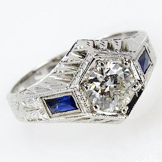 Circa 1930 Art Deco Approx. .90 Carat Round Cut Diamond and 18 Karat White Gold Engagement Ring with Calibre Cut Sapphire Acc