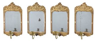 A Suite of Four Queen Anne Style Carved and Gilt Mirrored sconces