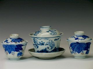 Three Chinese blue and white porcelain cups with lids.