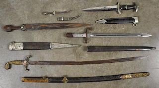 Five edged weapons and scabbards, to include a reproduction German WW II SS dagger and three North