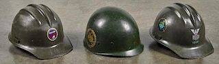 Two plastic Army helmets, to include one with Seabees sticker, one with Fighting 40 Seabees stic