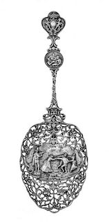A Dutch Silver Berry Spoon, Maker's mark zTz, 1920, bowl with central merrymaking scene surrounded by pierced scrolling foliage,