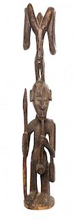 A Carved Wood Figure of a Hunter with Smoking Pipe, WEST AFRICA, MID 20TH CENTURY,
