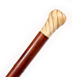 A 19TH C. MALACCA WOOD WALKING STICK WITH IVORY