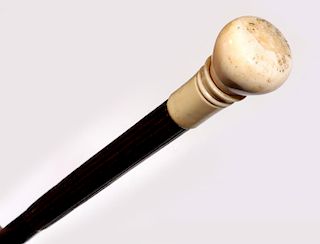 A 19TH CENTURY WALKING STICK WITH TURNED IVORY