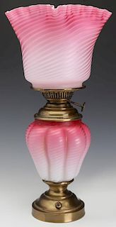 A FINE 19TH C. CRANBERRY SATIN AIR TRAP SWIRL LAMP