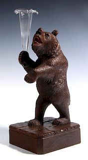 A GOOD BLACK FOREST CARVED WOOD BEAR WITH VASE